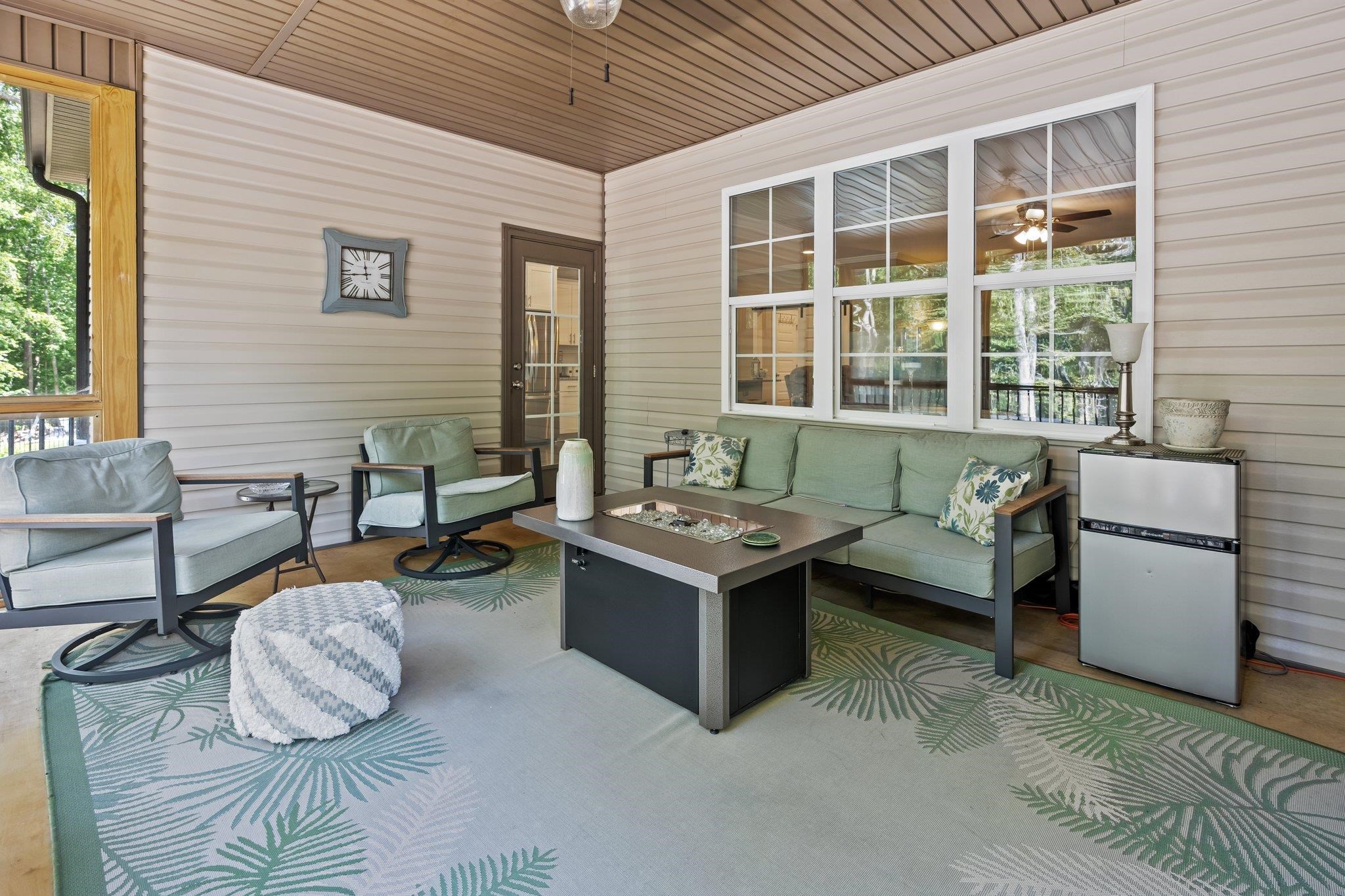 391 River Ridge Lane Timberlake, NC 27583 - Photo 38 of 47 a living room with furniture and a floor to ceiling window