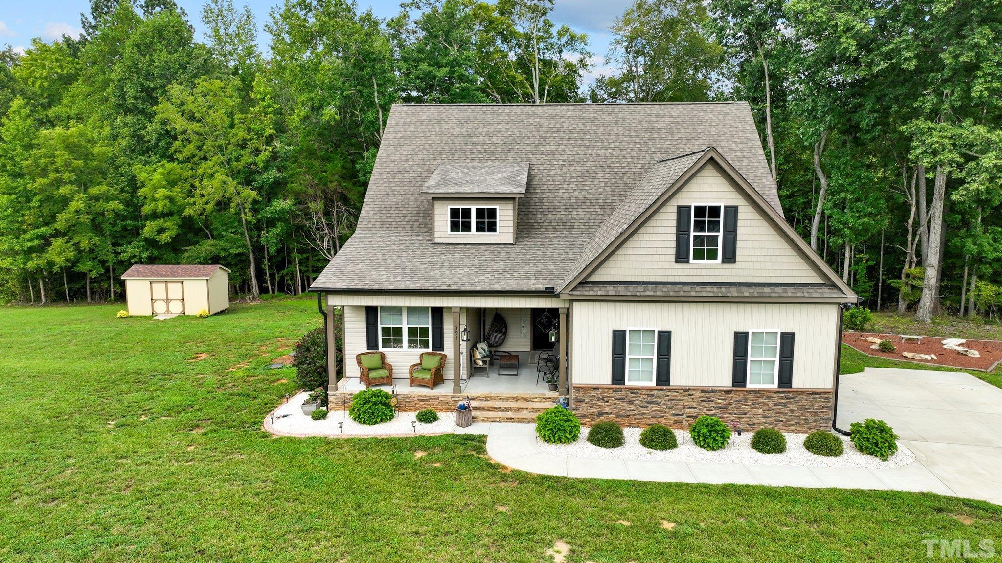 391 River Ridge Lane Timberlake, NC 27583 - Photo 40 of 47 a front view of a house with garden and porch