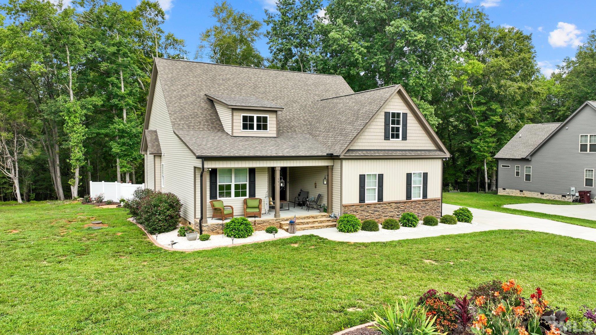 391 River Ridge Lane Timberlake, NC 27583 - Photo 42 of 47 a front view of a house with a yard and porch