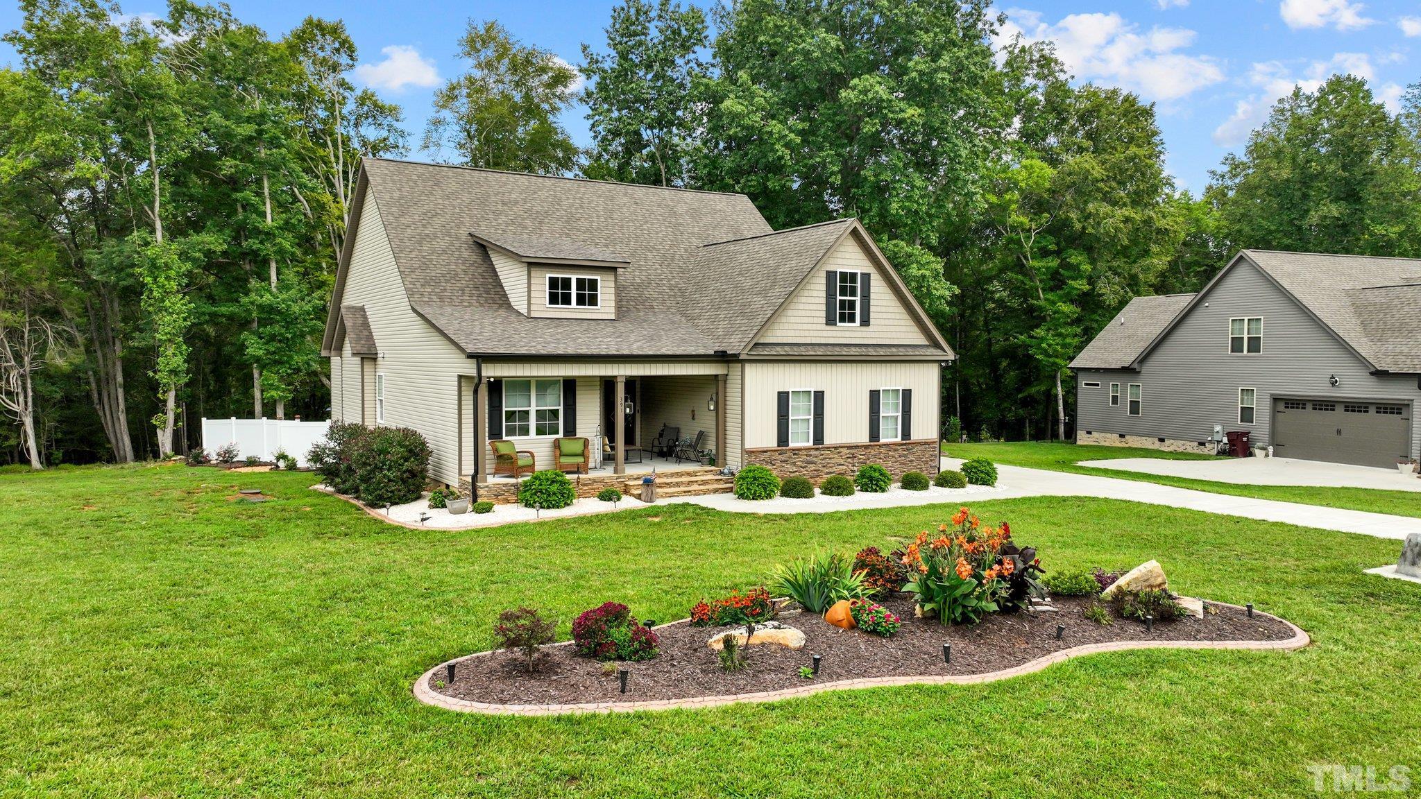 391 River Ridge Lane Timberlake, NC 27583 - Photo 43 of 47 a view of a house with swimming pool and a garden