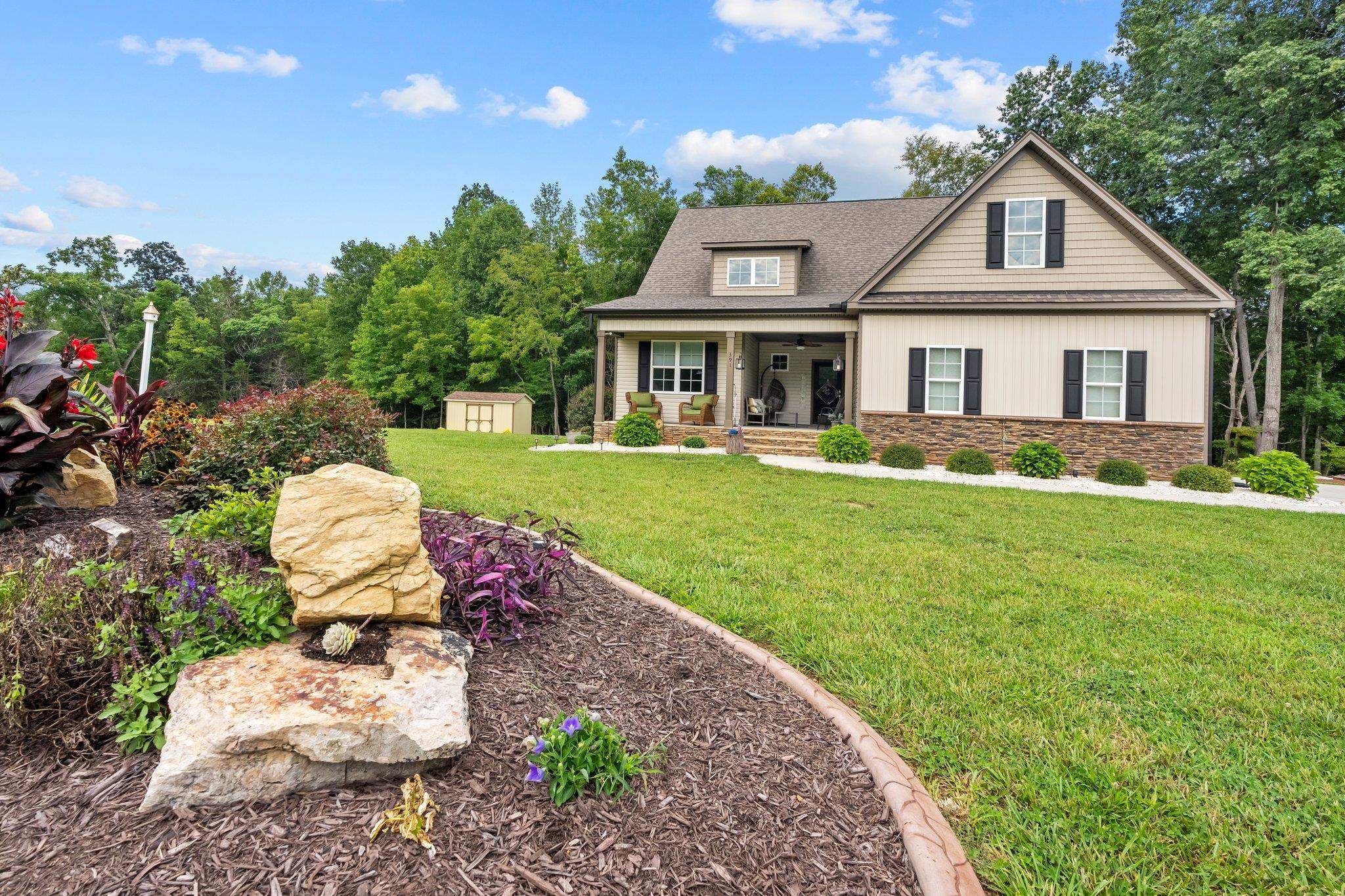 391 River Ridge Lane Timberlake, NC 27583 - Photo 45 of 47 a front view of a house with a yard and garage