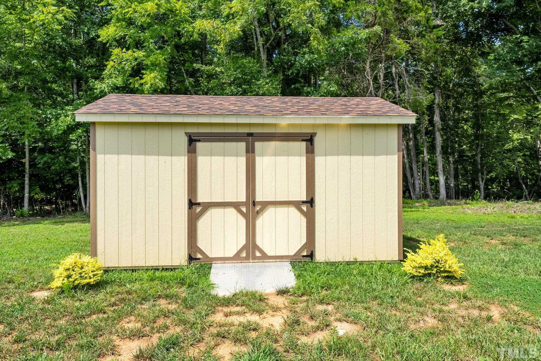 391 River Ridge Lane Timberlake, NC 27583 - Photo 46 of 47 a backyard of a house with table and chairs