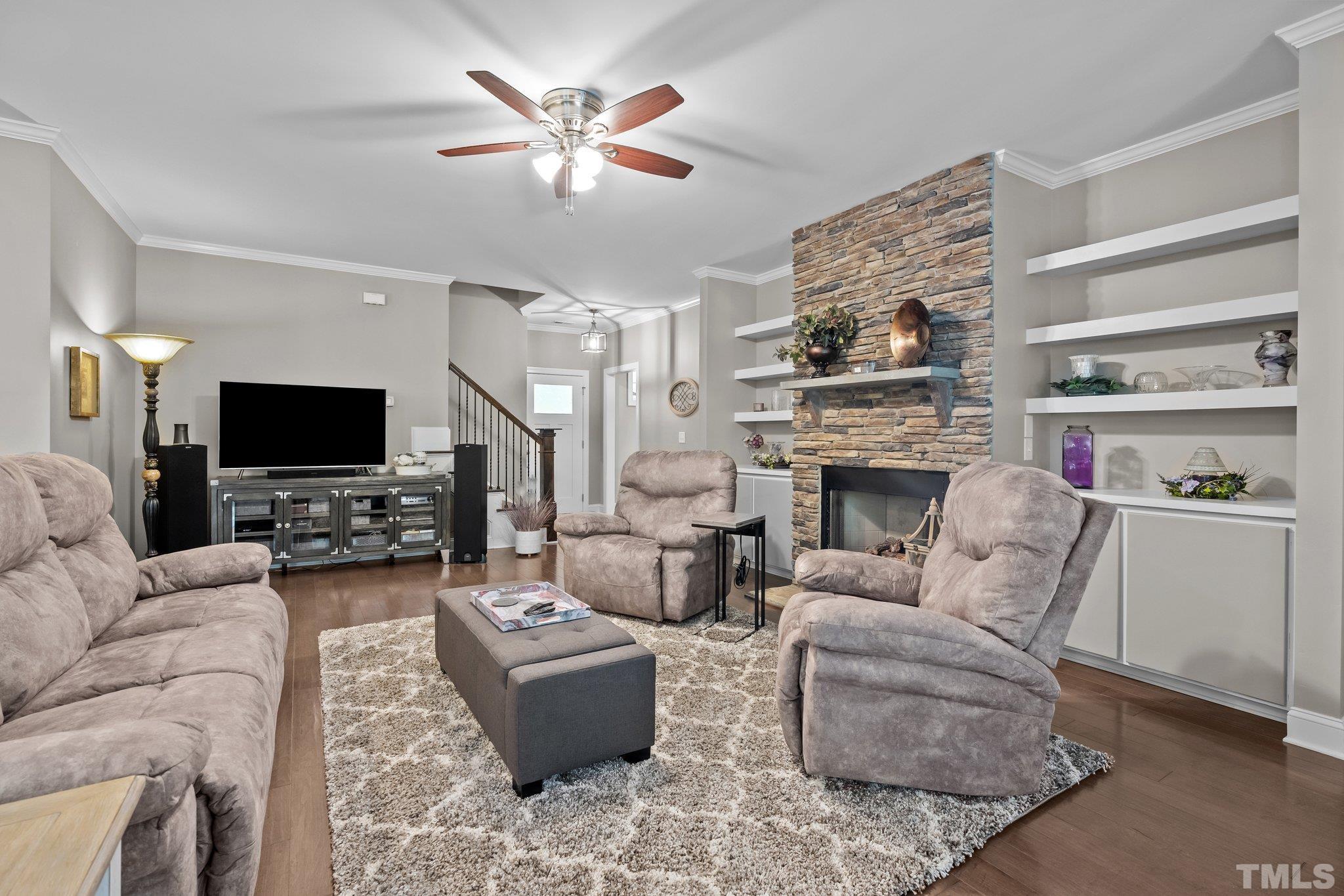 391 River Ridge Lane Timberlake, NC 27583 - Photo 9 of 47 a living room with furniture a flat screen tv and a fireplace