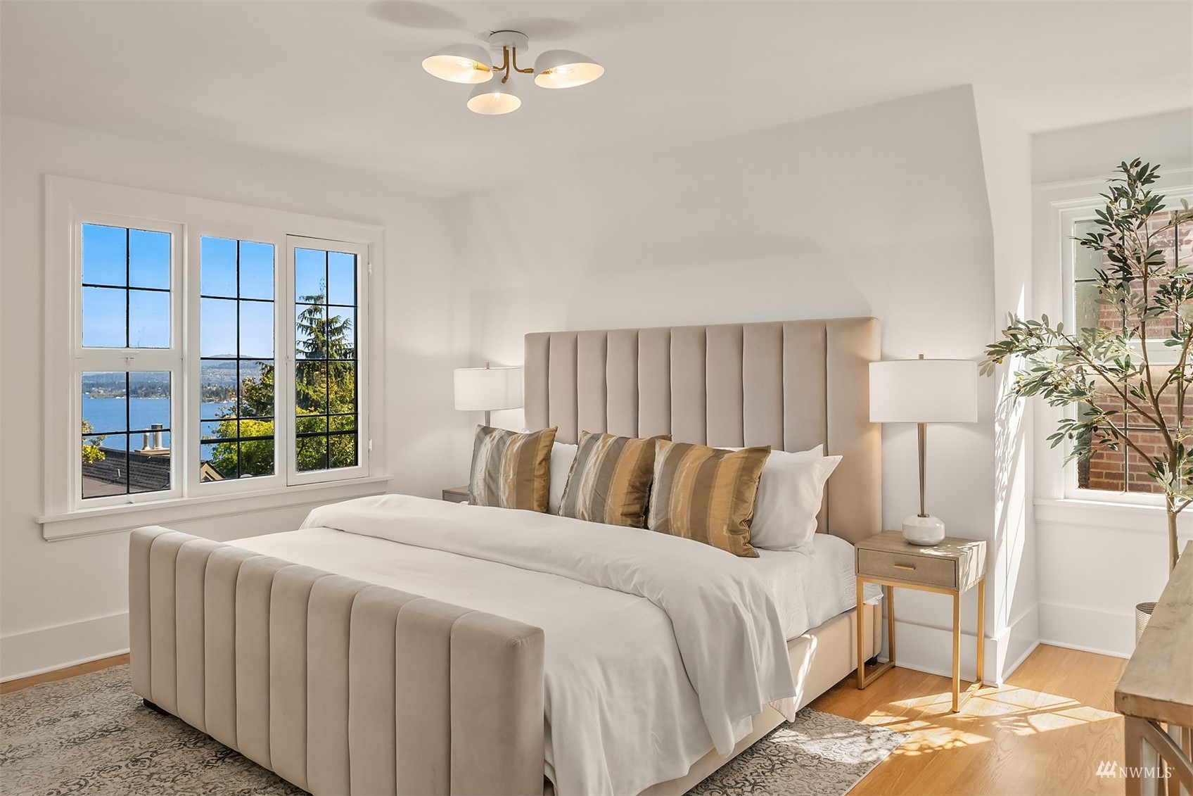 732 36th Avenue Seattle, WA 98122 - Photo 16 of 37 a bedroom with a bed and a chandelier