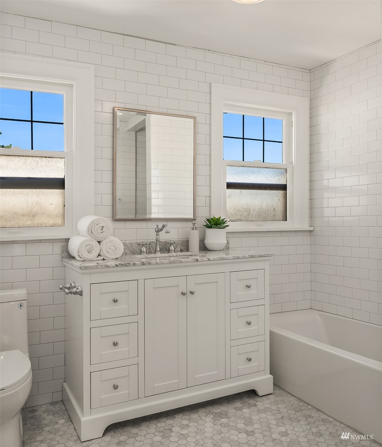 732 36th Avenue Seattle, WA 98122 - Photo 18 of 37 a bathroom with a granite countertop sink a large mirror a toilet and bathtub