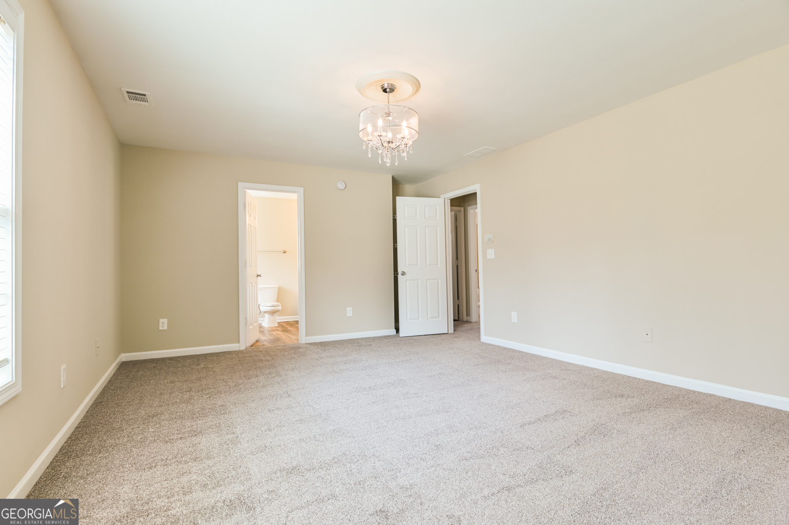 1766 Laurel Ridge Drive Southwest Conyers, GA 30094 - Photo 16 of 61 a view of an empty room with a chandelier fan