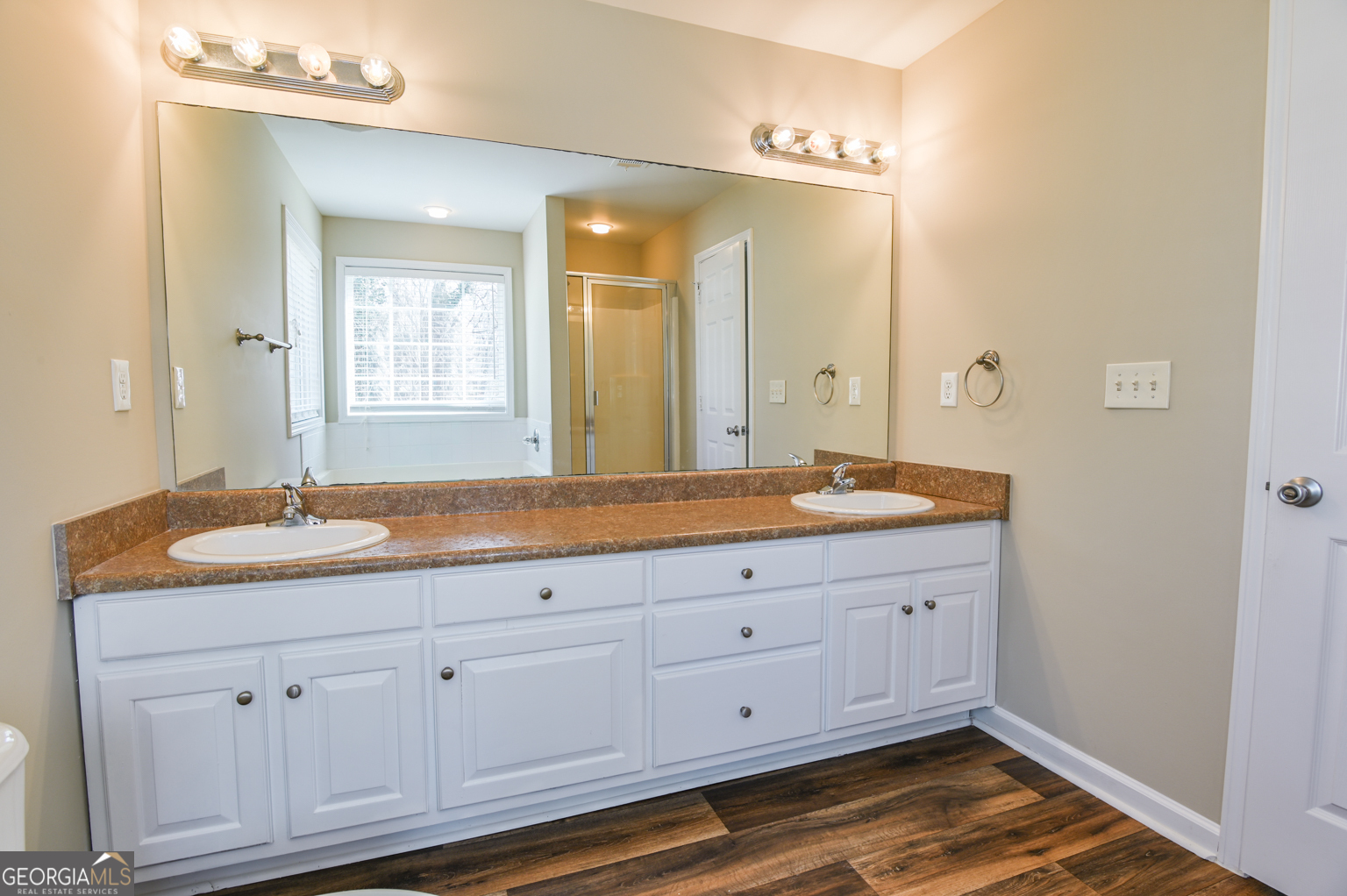 1766 Laurel Ridge Drive Southwest Conyers, GA 30094 - Photo 18 of 61 a bathroom with a granite countertop double vanity sink a mirror and shower