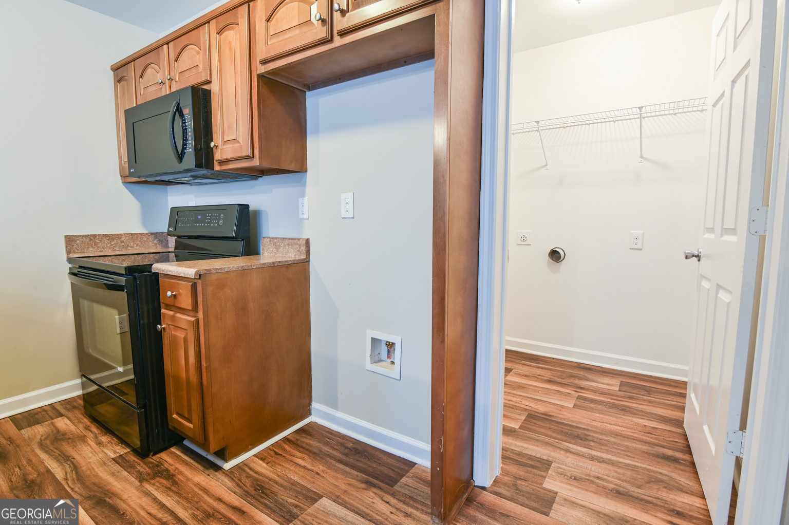 1766 Laurel Ridge Drive Southwest Conyers, GA 30094 - Photo 32 of 61 a view of a kitchen with fridge and wooden floor