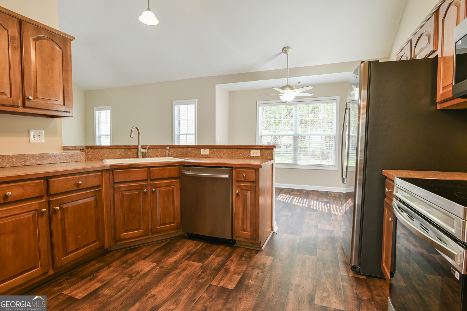 1766 Laurel Ridge Drive Southwest Conyers, GA 30094 - Photo 6 of 61 a kitchen with stainless steel appliances granite countertop a stove a sink and a refrigerator