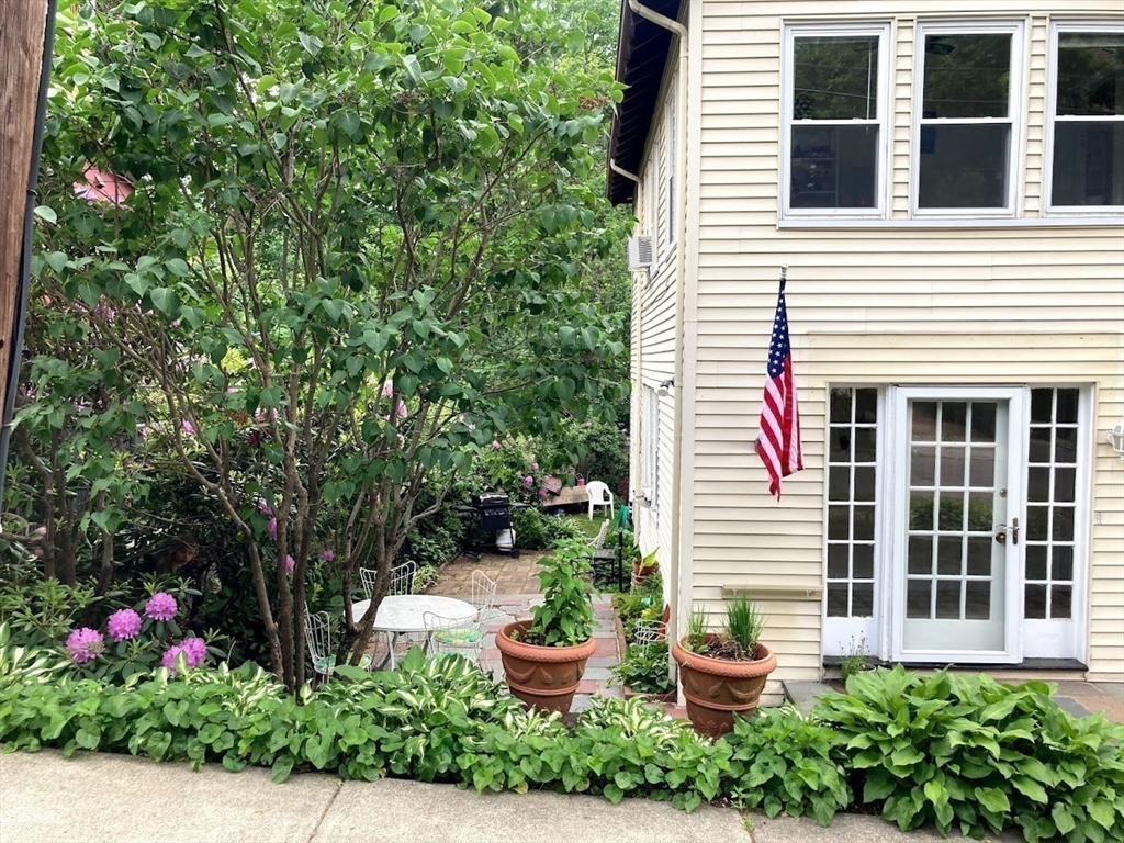 28 Beaconsfield Road, Unit 1 Brookline, MA 02445 - Photo 3 of 21 a front view of a house with a yard and potted plants