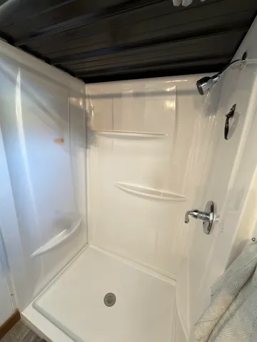 a bathroom with a glass shower door