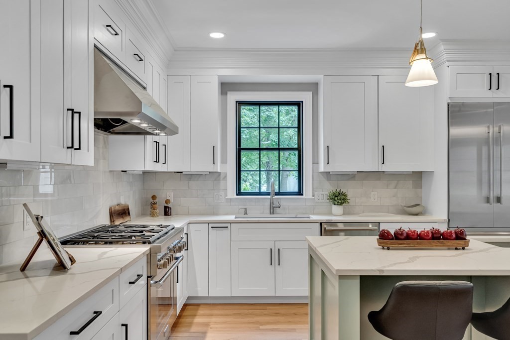 6 Park Street Lexington, MA 02421 - Photo 13 of 42 a kitchen with stainless steel appliances granite countertop a sink stove refrigerator and cabinets