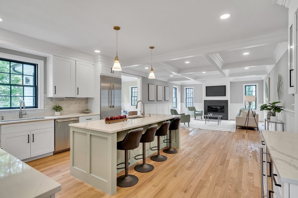 6 Park Street Lexington, MA 02421 - Photo 21 of 42 a kitchen with stainless steel appliances granite countertop a table chairs refrigerator and sink