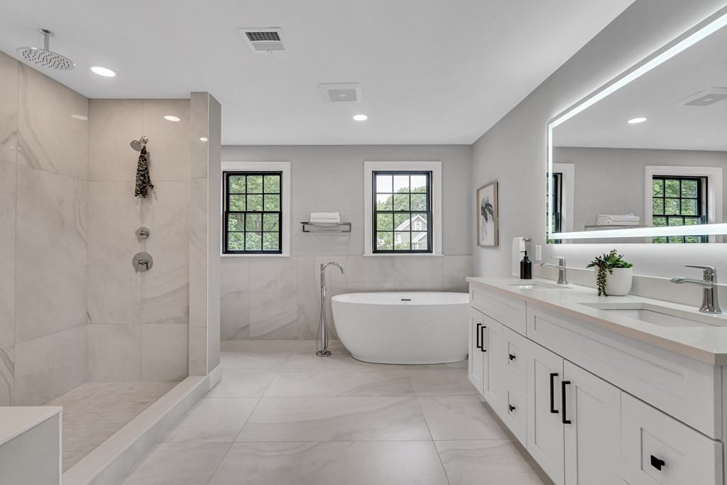 6 Park Street Lexington, MA 02421 - Photo 24 of 42 a bathroom with a granite countertop sink a toilet a mirror and shower