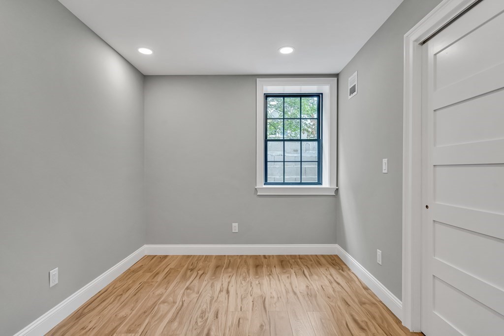 6 Park Street Lexington, MA 02421 - Photo 29 of 42 wooden floor in an empty room with a window