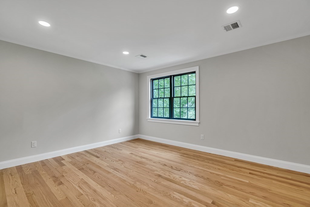 6 Park Street Lexington, MA 02421 - Photo 33 of 42 wooden floor in an empty room with a window