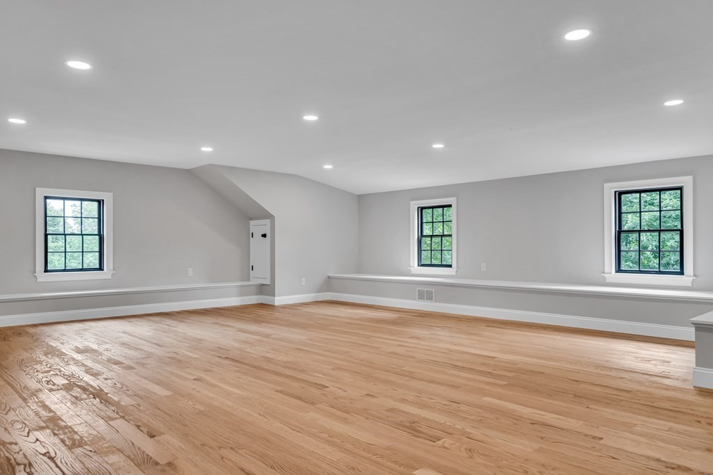 6 Park Street Lexington, MA 02421 - Photo 36 of 42 an empty room with wooden floor and windows