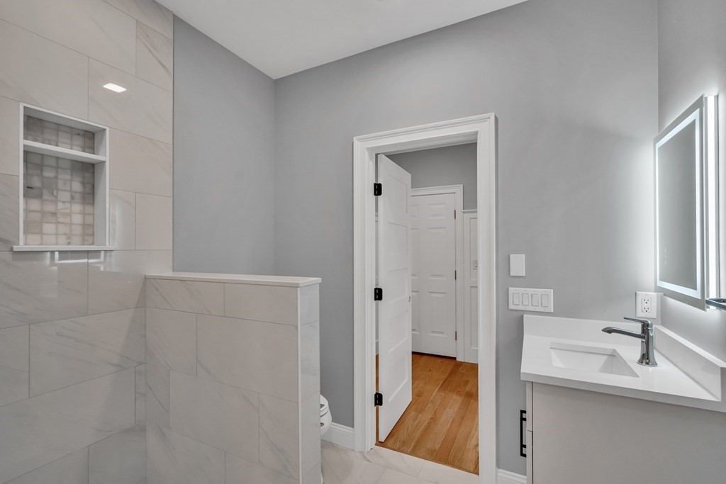6 Park Street Lexington, MA 02421 - Photo 9 of 42 a view of a bathroom from a hallway