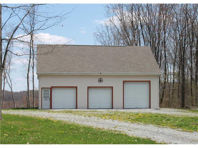 489 Clearfield Road Cabot, PA 16023 - Photo 3 of 18 Parking Lot/Garage. The 4 car garage has high ceilings and a upper level for storage or possible game room.