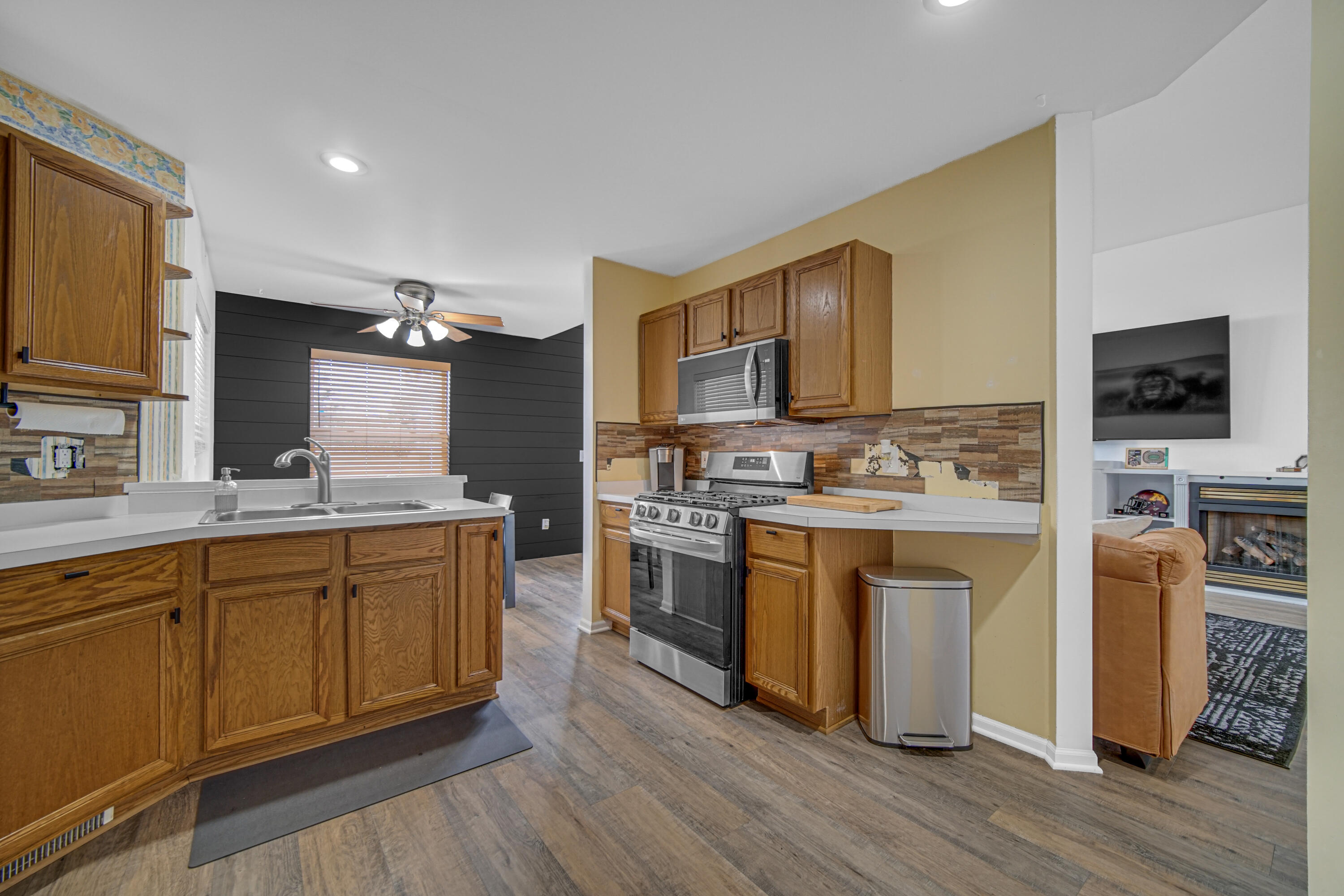 11130 Allendale Court Crown Point, IN 46307 - Photo 6 of 21 a kitchen with stainless steel appliances granite countertop a stove top oven a sink dishwasher a refrigerator and a oven with wooden floor