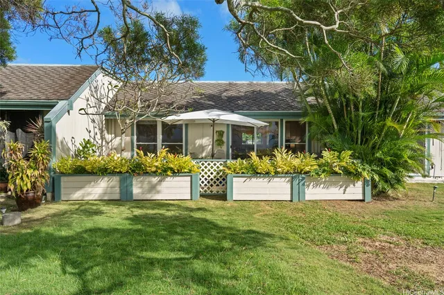 a front view of house with yard and outdoor seating