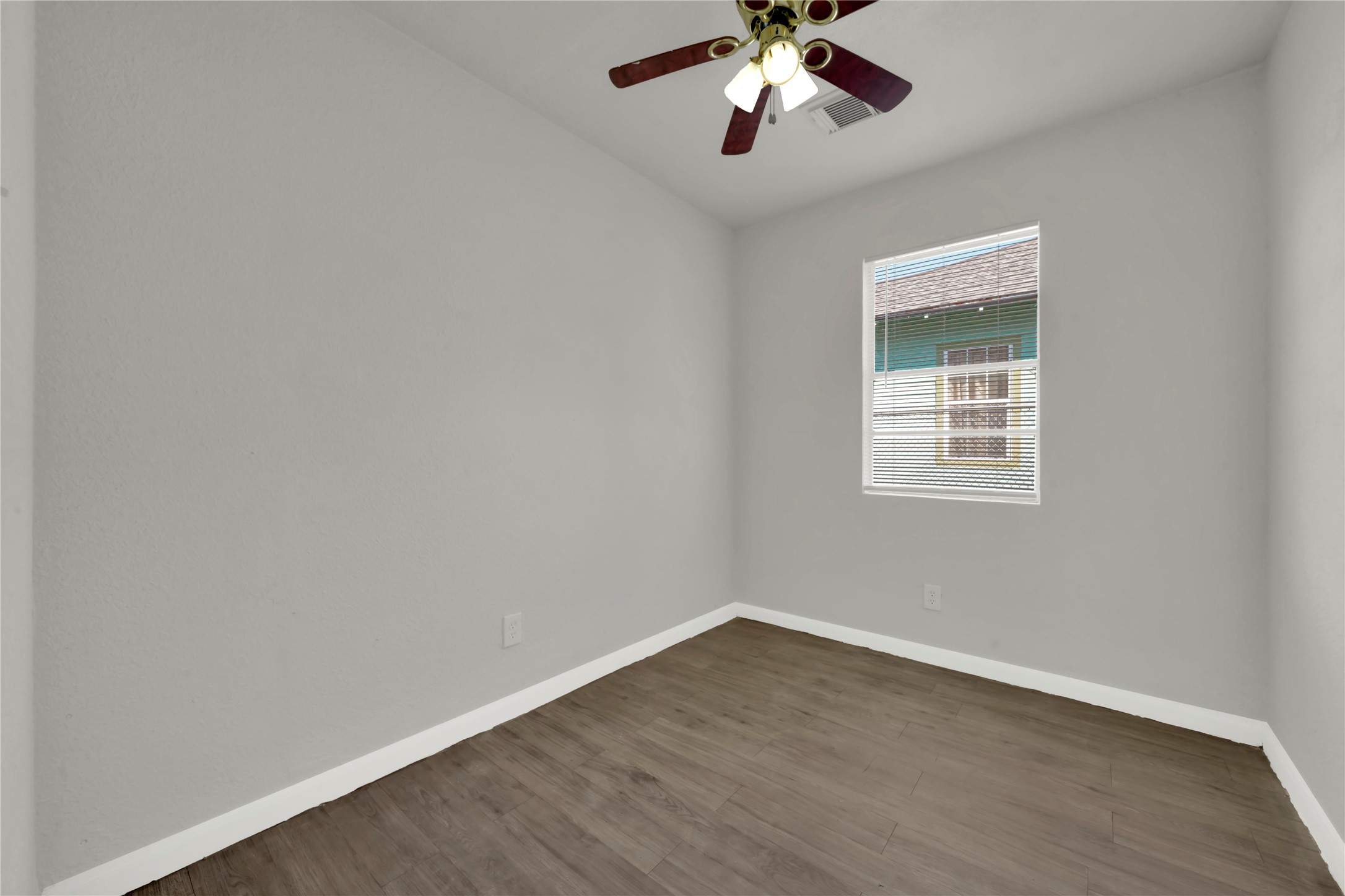 106 Hanover Street Houston, TX 77012 - Photo 13 of 49 a view of an empty room with wooden floor and a window
