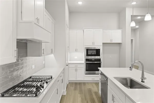 a view of kitchen with sink and wooden floor