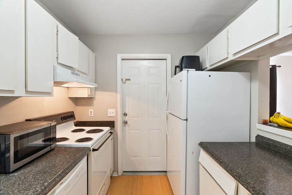 1410 Moore Avenue Portland, TX 78374 - Photo 5 of 17 a kitchen with a refrigerator sink and stove