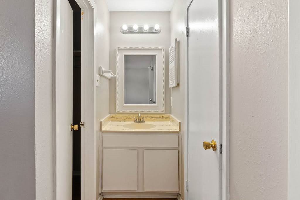 1410 Moore Avenue Portland, TX 78374 - Photo 9 of 17 a bathroom with a granite countertop sink and a mirror