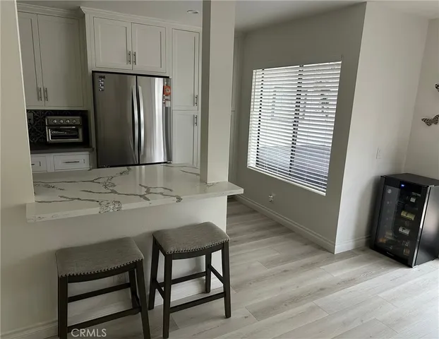 a kitchen with stainless steel appliances granite countertop a refrigerator and a stove top oven