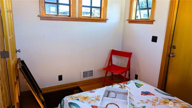 a view of empty room with wooden floor