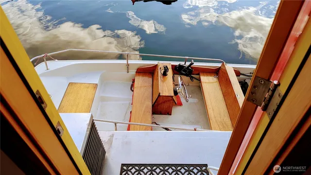 a view of a rooftop deck with couch and chairs