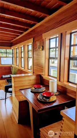 a living room with stainless steel appliances granite countertop a sink and a counter