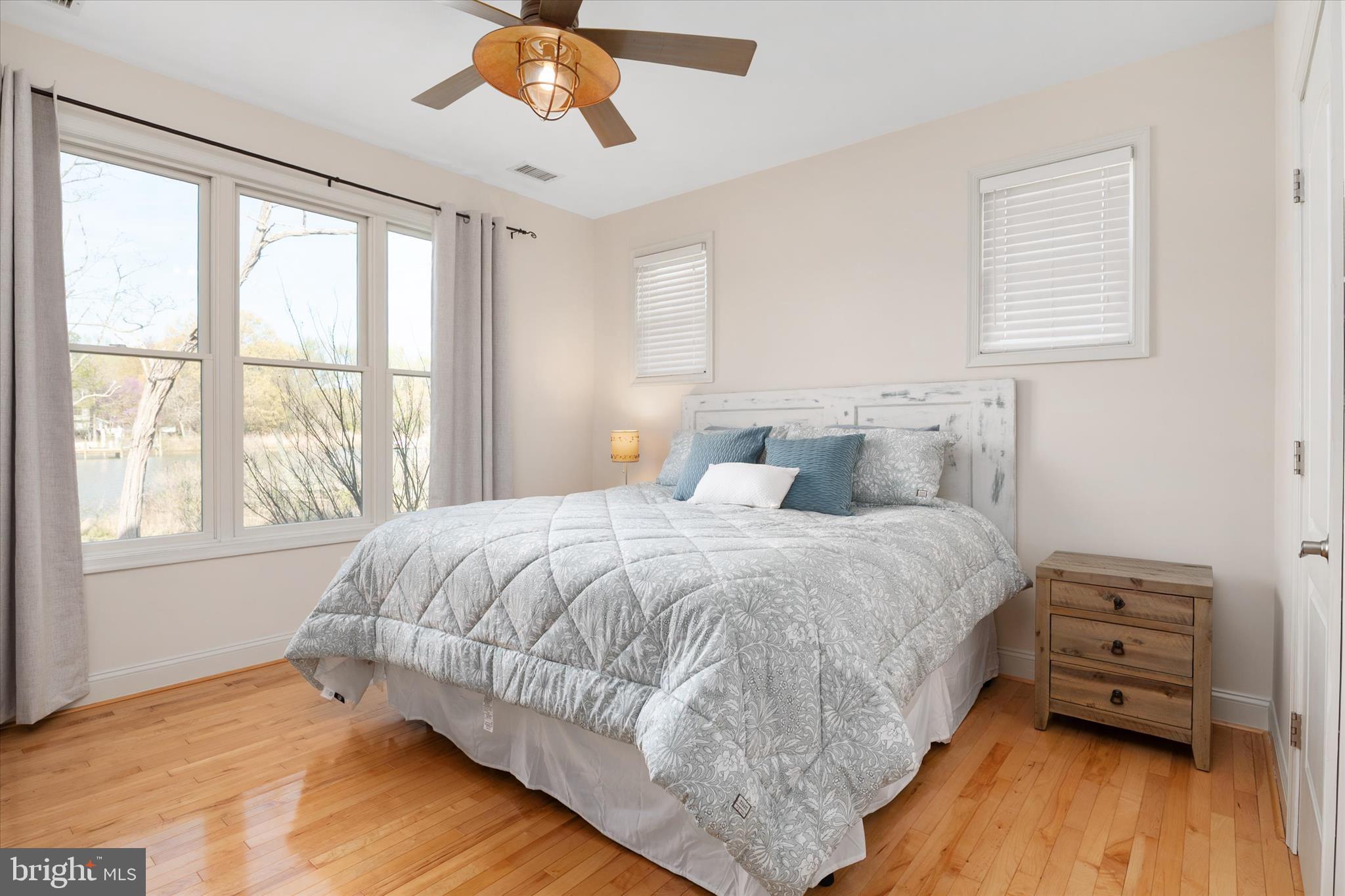 5936 Sneed Drive Deale, MD 20751 - Photo 18 of 59 a bedroom with a bed and wooden floor