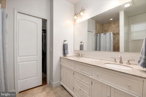 a bathroom with double sink and a mirror