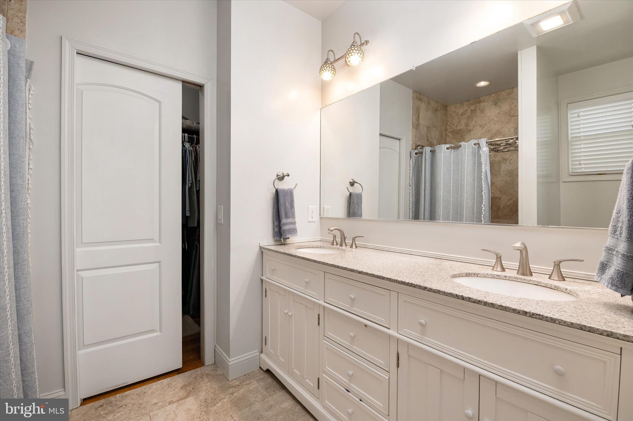 5936 Sneed Drive Deale, MD 20751 - Photo 20 of 59 a bathroom with double sink and a mirror
