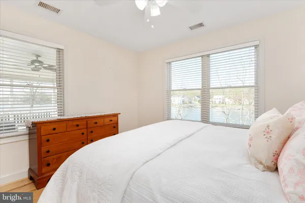 a bathroom with a granite countertop toilet sink and mirror