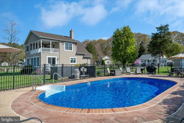 a view of a swimming pool with a patio and a garden
