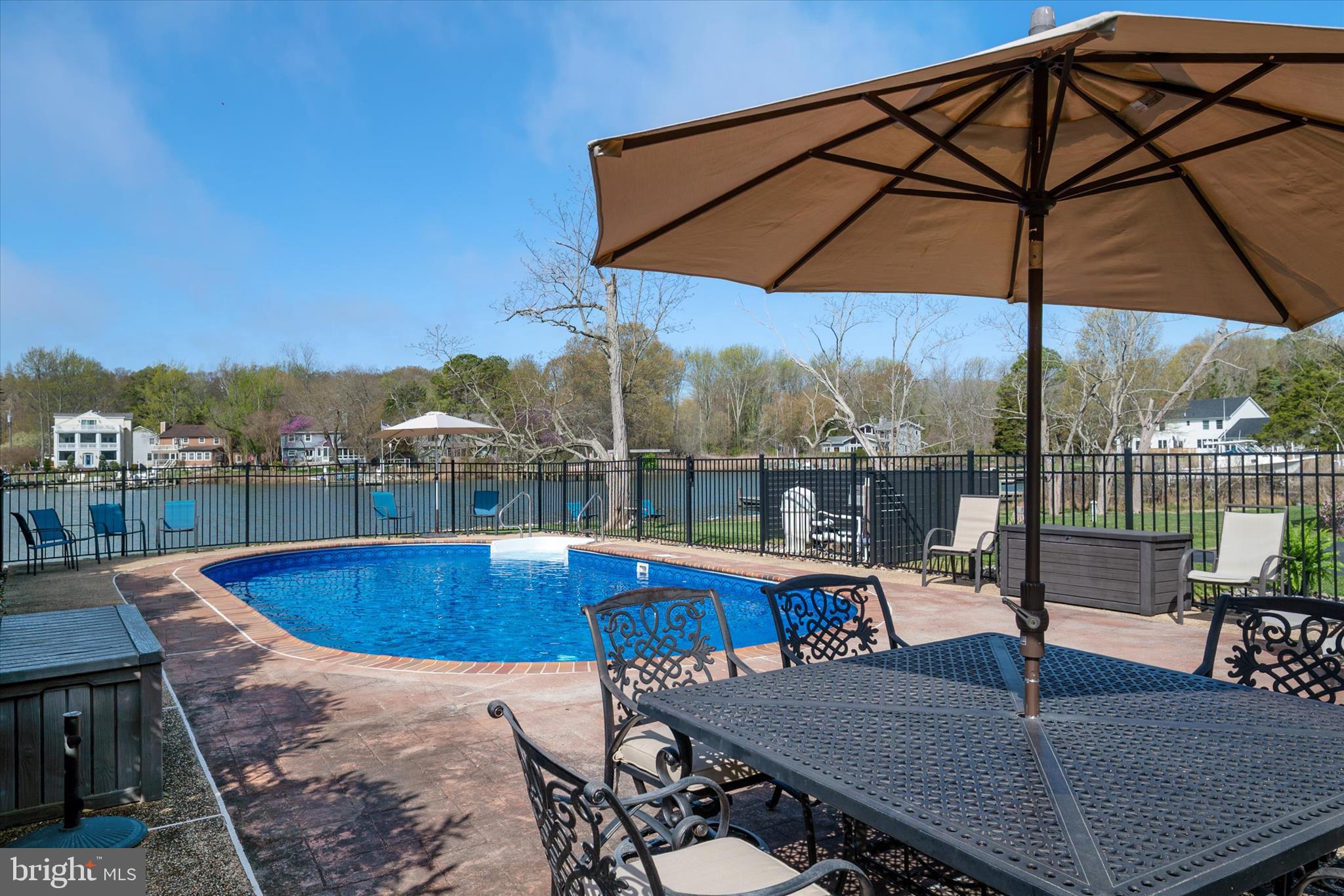 5936 Sneed Drive Deale, MD 20751 - Photo 38 of 59 a view of swimming pool with a table and chairs under an umbrella