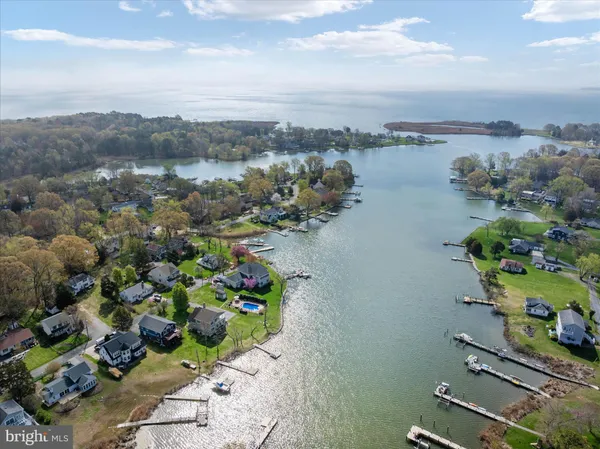 an aerial view of a house with swimming pool outdoor seating and yard