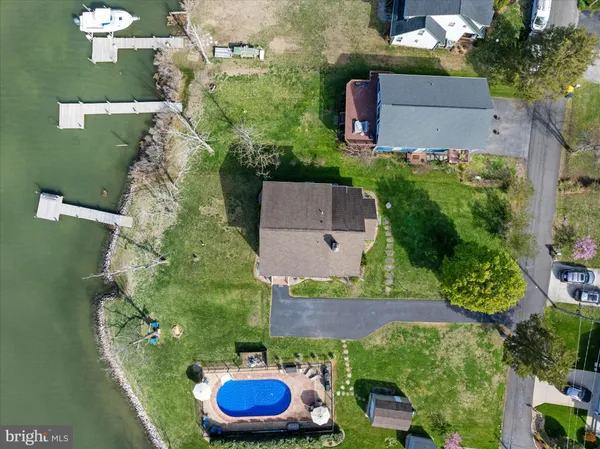 an aerial view of residential house with outdoor space and lake view