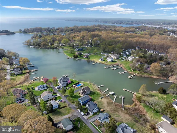 an aerial view of a house with a yard and lake view