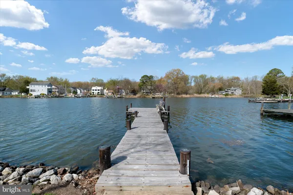 a front view of a house with a yard table and chairs