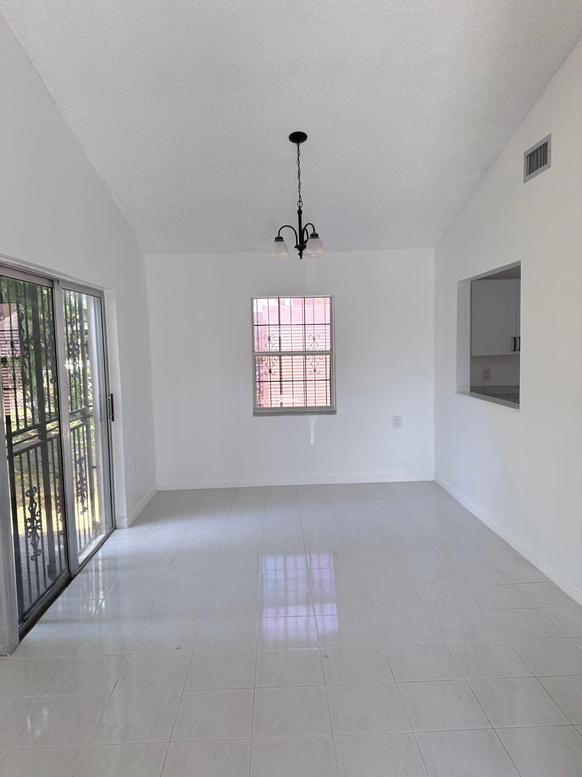 12231 Southwest 210th Street Miami, FL 33177 - Photo 11 of 38 a view of an empty room with a window