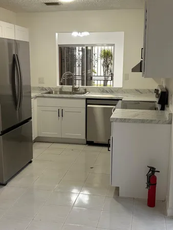 a kitchen with a sink and refrigerator