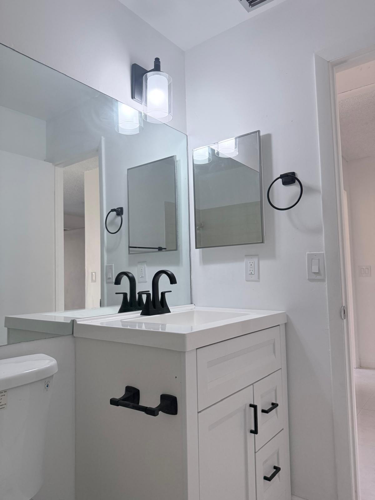 12231 Southwest 210th Street Miami, FL 33177 - Photo 24 of 38 a bathroom with a sink a toilet and mirror