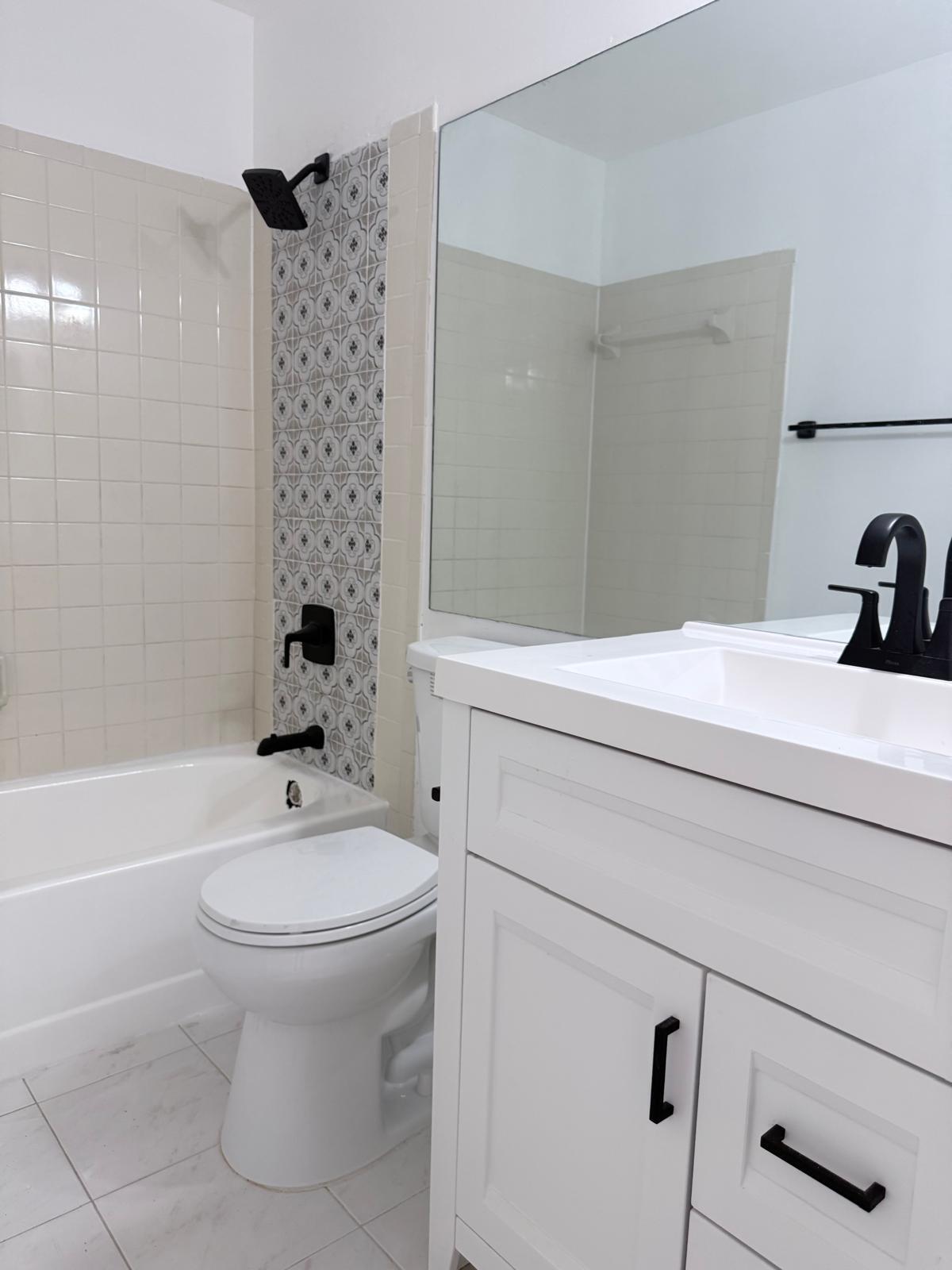 12231 Southwest 210th Street Miami, FL 33177 - Photo 25 of 38 a bathroom with a sink toilet and shower