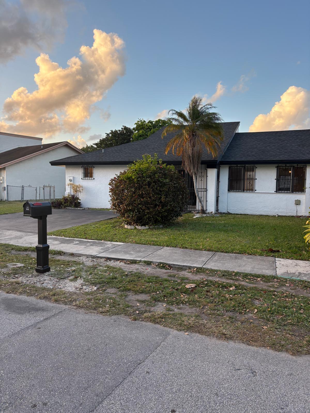 12231 Southwest 210th Street Miami, FL 33177 - Photo 3 of 38 a view of a house with a yard