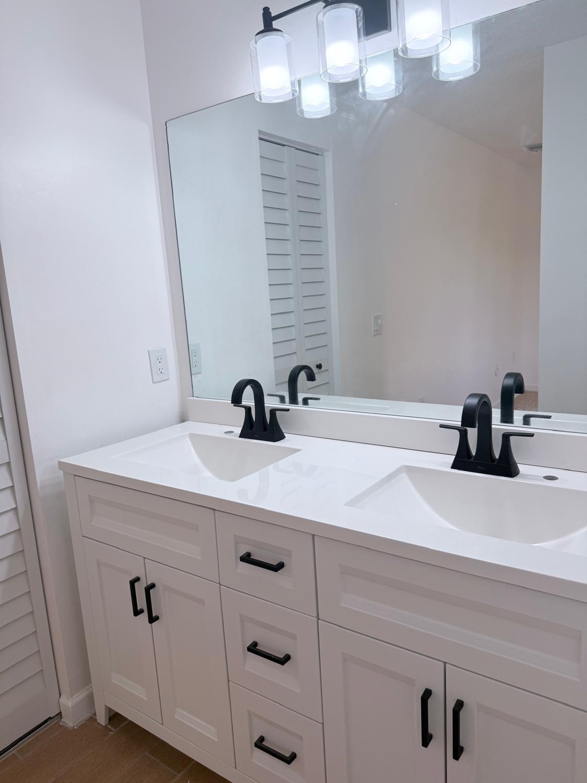 12231 Southwest 210th Street Miami, FL 33177 - Photo 31 of 38 a bathroom with a sink and a mirror