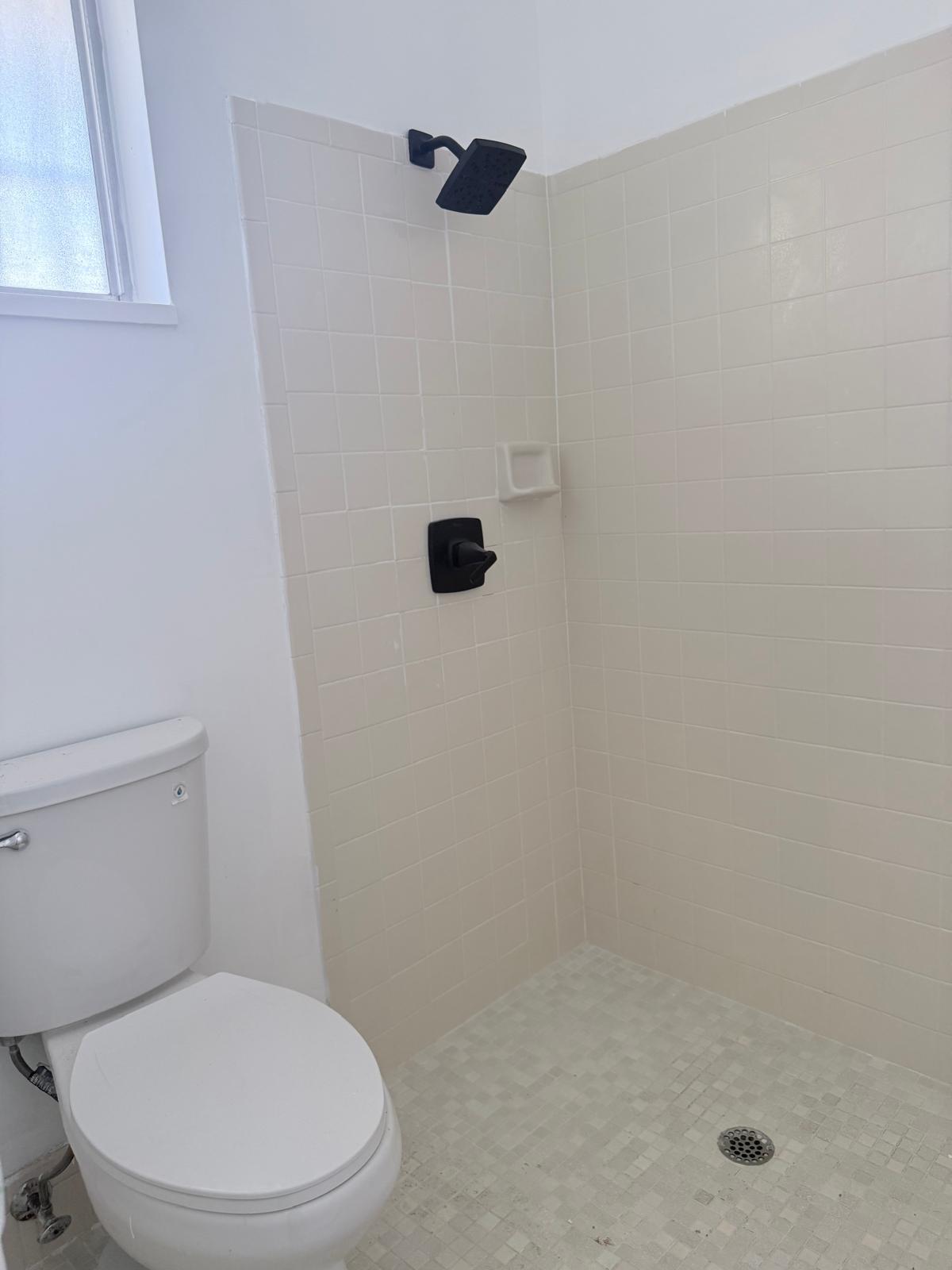 12231 Southwest 210th Street Miami, FL 33177 - Photo 32 of 38 a white toilet sitting next to a shower